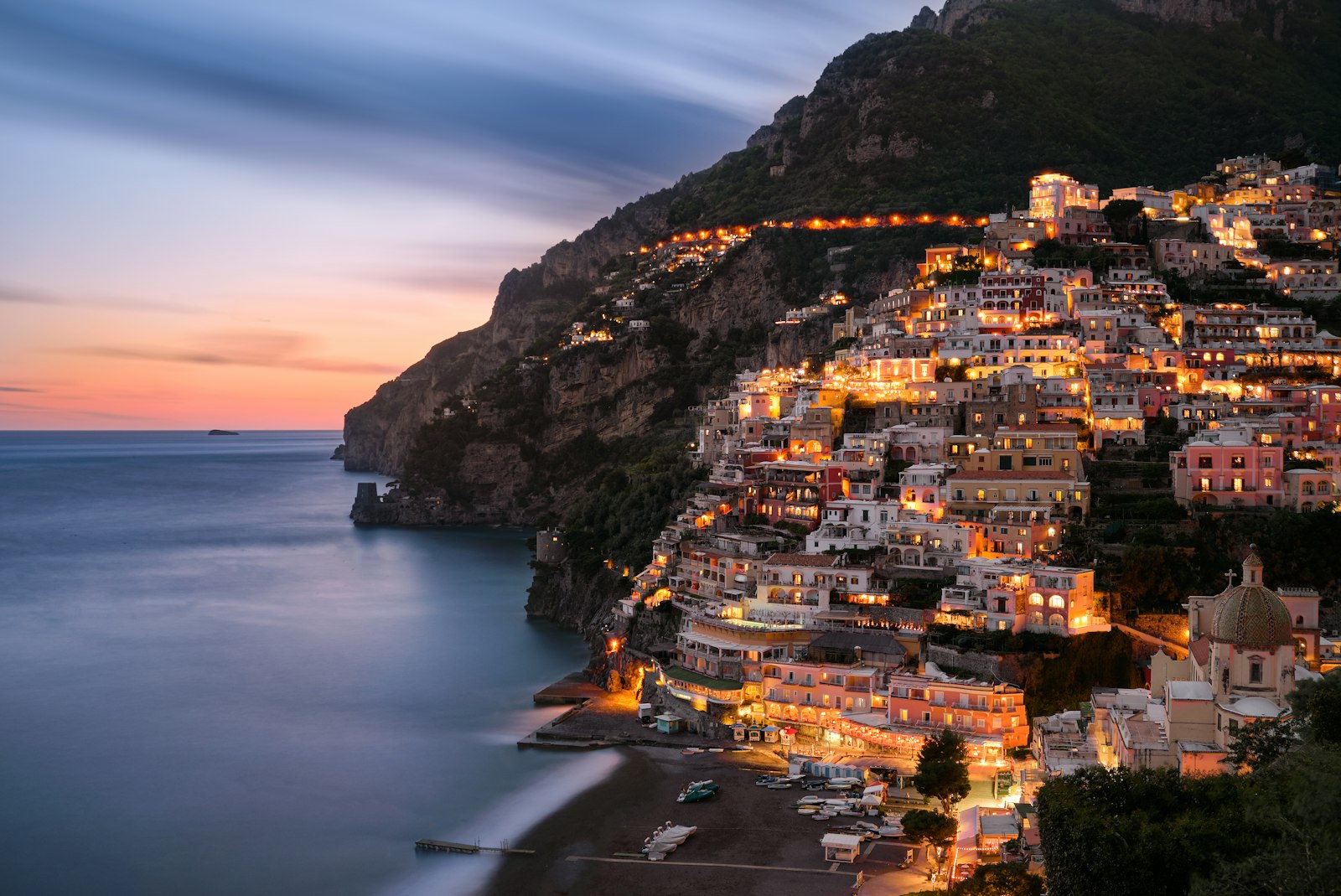 Pastel houses stacked above the sea on the Amalfi Coast