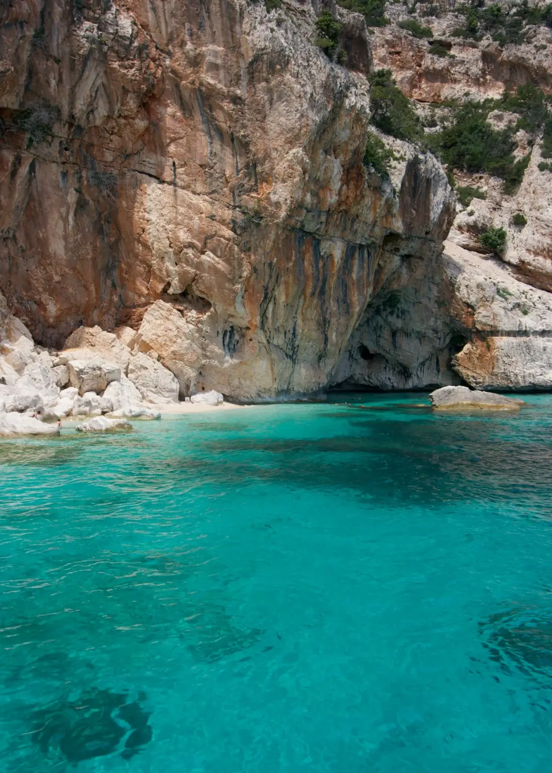Clear water by a rocky cliff in Sardinia